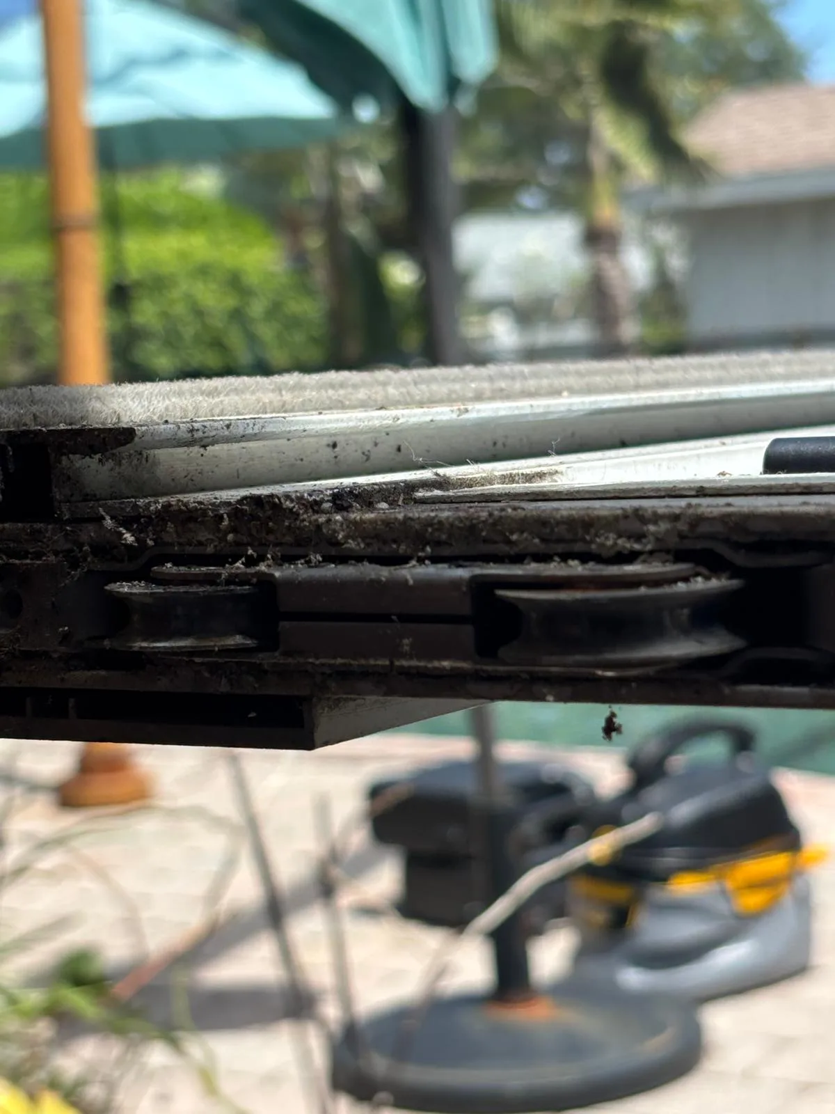 Rusted sliding door rollers corroded by coastal Florida salt air